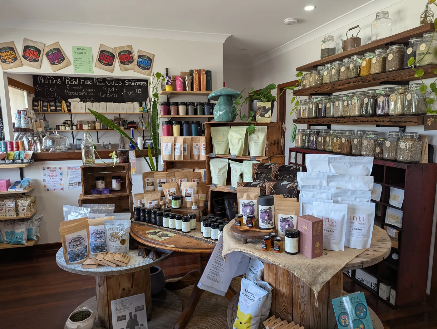Inside the shop: the coffee counter, timber displays and wall of loose herbs